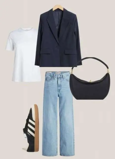 Women's essential clothing pieces, including a classic white shirt, a pair of well-fitting jeans, and a leather jacket, laid out on a table.